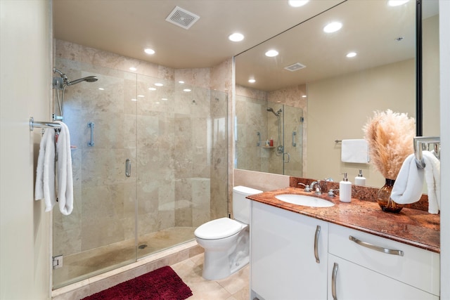 bathroom with tile patterned flooring, vanity, toilet, and walk in shower