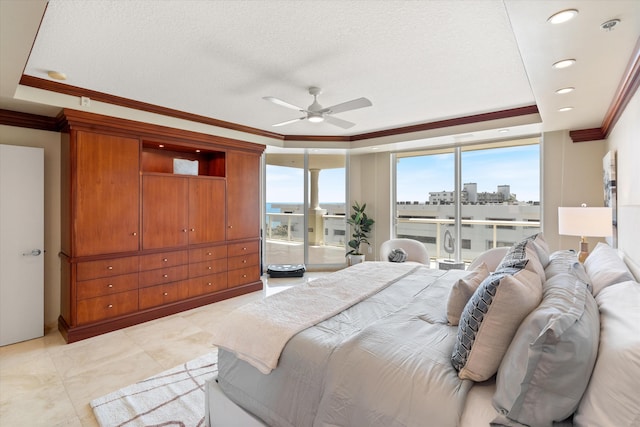 bedroom with ceiling fan, a raised ceiling, a textured ceiling, access to outside, and ornamental molding