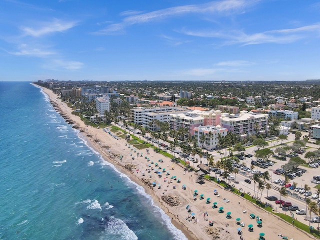 drone / aerial view featuring a beach view and a water view