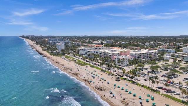 drone / aerial view with a beach view and a water view