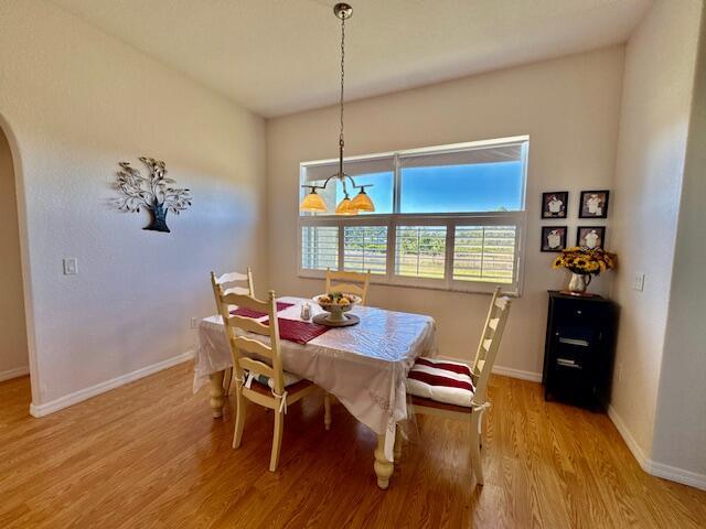 dining room featuring a notable chandelier and light wood-type flooring