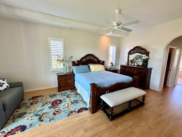 bedroom with ceiling fan and light hardwood / wood-style floors