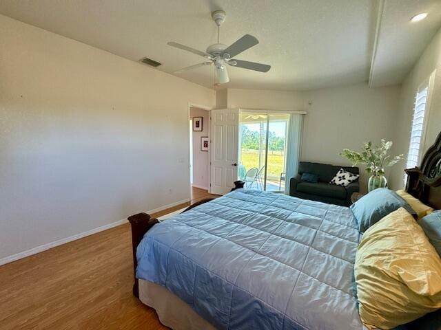 bedroom with access to outside, ceiling fan, and wood-type flooring