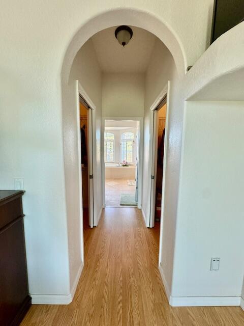 hallway with light hardwood / wood-style flooring