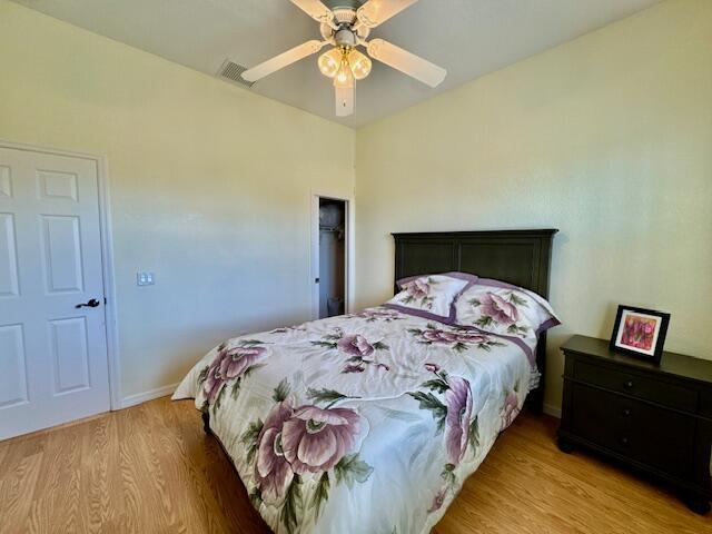 bedroom featuring light wood-type flooring and ceiling fan