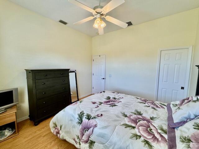 bedroom with light hardwood / wood-style flooring and ceiling fan