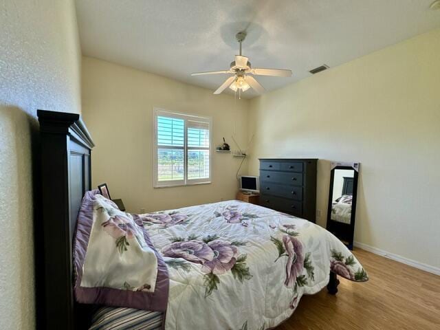 bedroom featuring ceiling fan and light wood-type flooring