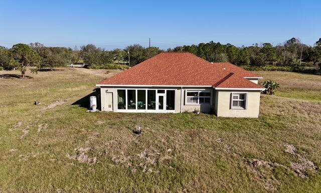 rear view of property with a yard