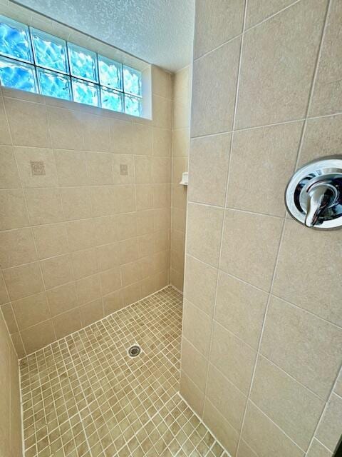 bathroom with tiled shower