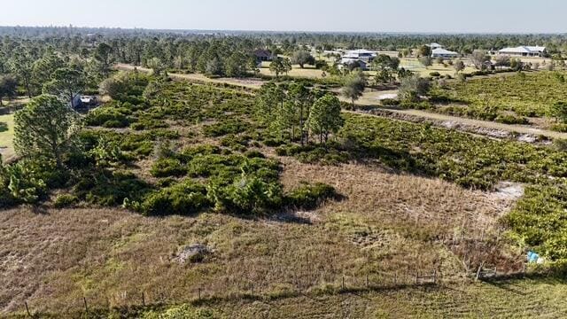 birds eye view of property with a rural view