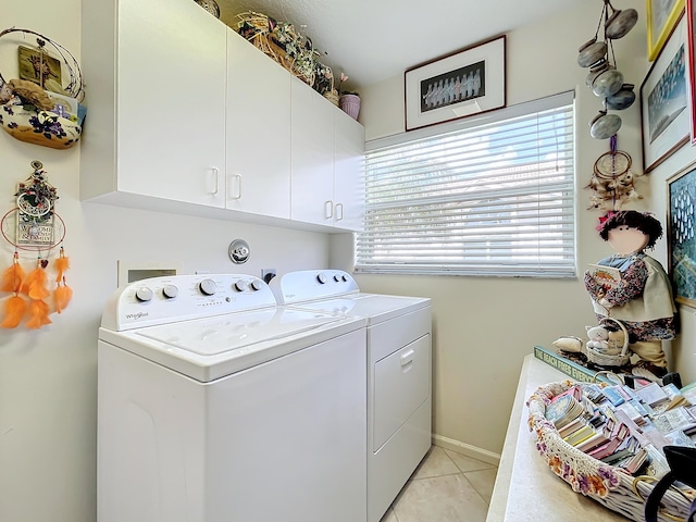 washroom featuring cabinets, independent washer and dryer, and light tile patterned floors