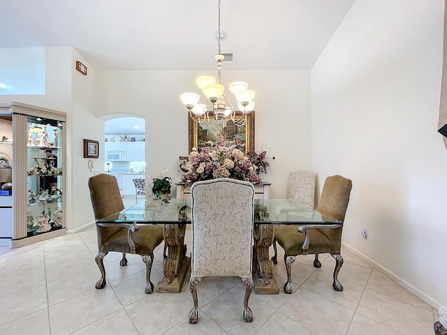 dining space with a chandelier and light tile patterned flooring