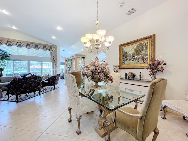 tiled dining area featuring a chandelier and vaulted ceiling