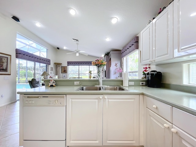 kitchen with kitchen peninsula, dishwasher, white cabinets, and sink