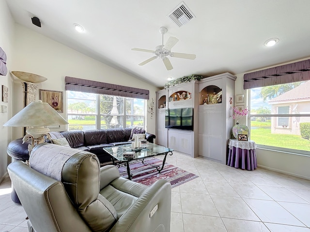 tiled living room featuring ceiling fan, lofted ceiling, and a wealth of natural light