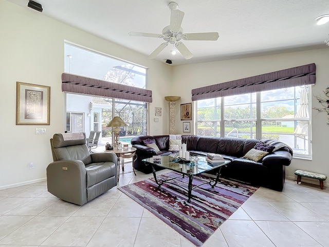 tiled living room featuring a wealth of natural light, ceiling fan, and vaulted ceiling