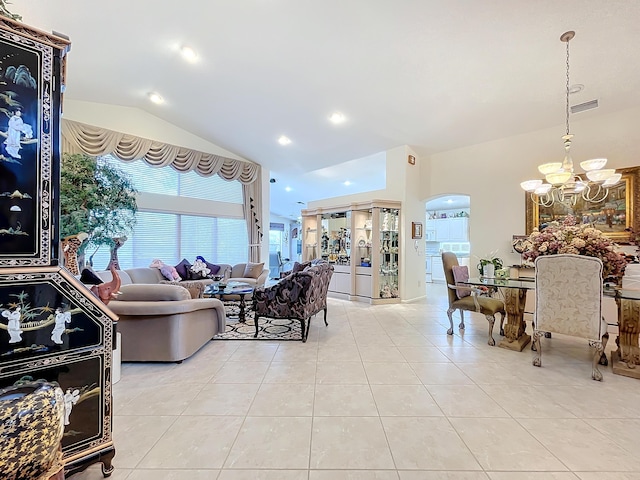 tiled living room featuring a notable chandelier and vaulted ceiling