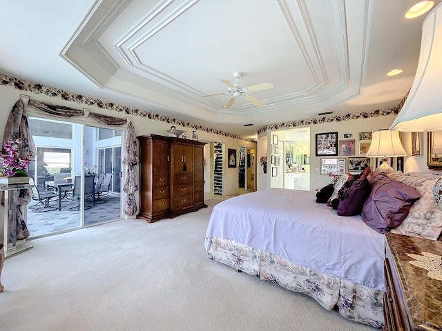 bedroom featuring ceiling fan, a raised ceiling, light carpet, and access to outside