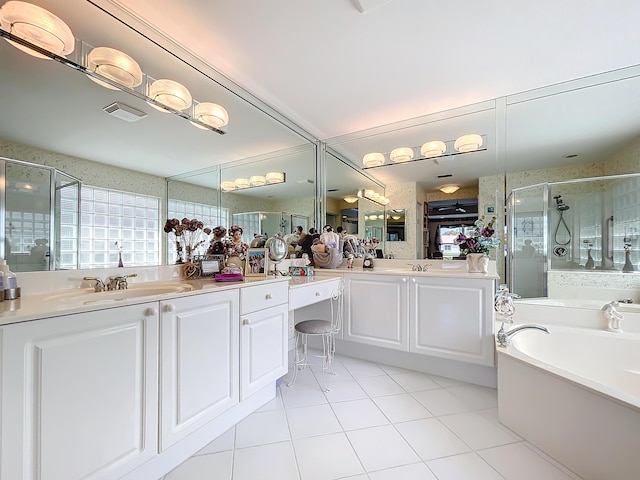 bathroom with tile patterned floors, vanity, and shower with separate bathtub