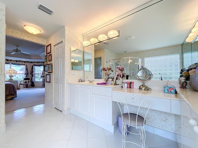 bathroom featuring walk in shower, ornamental molding, vanity, ceiling fan, and tile patterned flooring