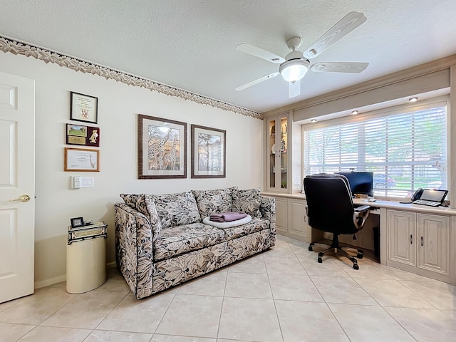 tiled home office with a textured ceiling and ceiling fan