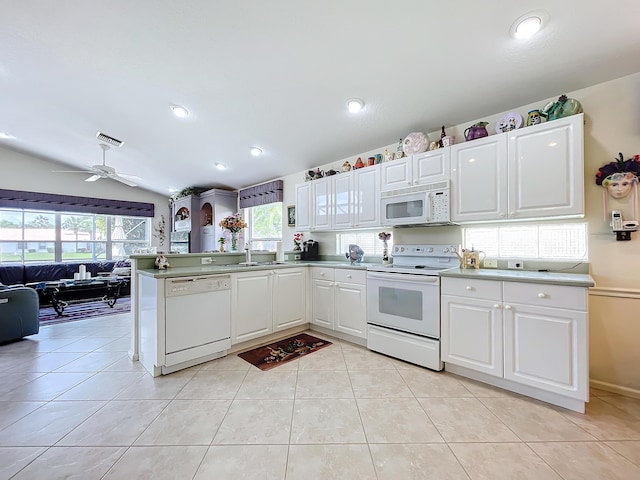 kitchen with white appliances, white cabinets, vaulted ceiling, ceiling fan, and kitchen peninsula