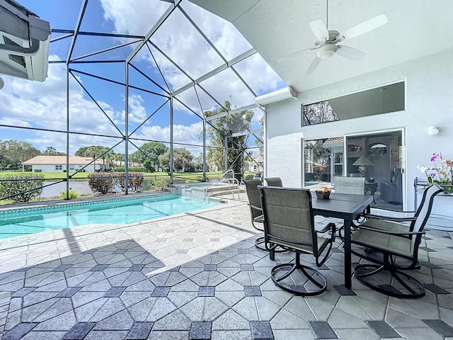 view of pool with ceiling fan, a patio area, and glass enclosure