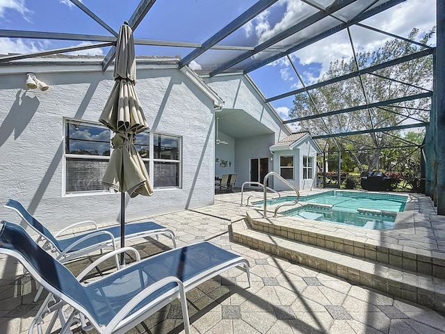 view of pool with an in ground hot tub, a lanai, and a patio area