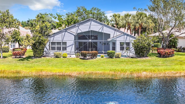 back of house with a lanai and a water view