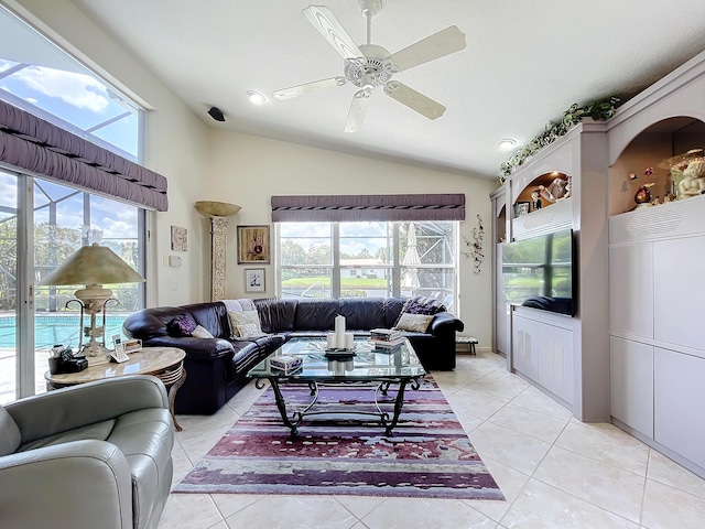 tiled living room with plenty of natural light, ceiling fan, and vaulted ceiling