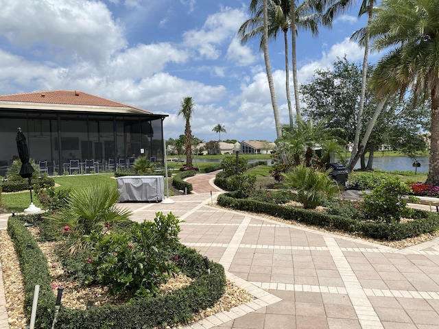 view of yard with a water view and a sunroom