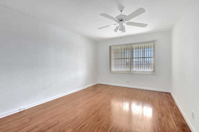 spare room featuring light wood-type flooring and ceiling fan