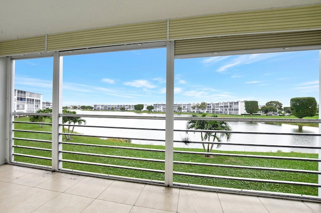 unfurnished sunroom featuring a water view