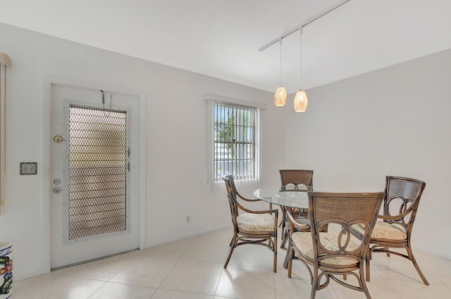 tiled dining space with plenty of natural light and a chandelier