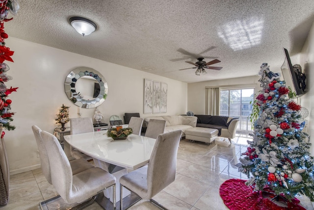 dining room with ceiling fan and a textured ceiling