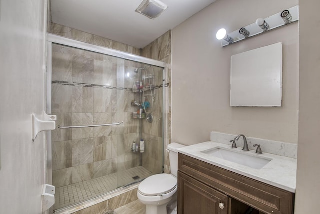 bathroom with vanity, toilet, and an enclosed shower