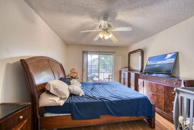 4125 NW 88th Ave Unit 202, Coral Springs, FL 33065 - bedroom featuring a textured ceiling, wood finished floors, and ceiling fan