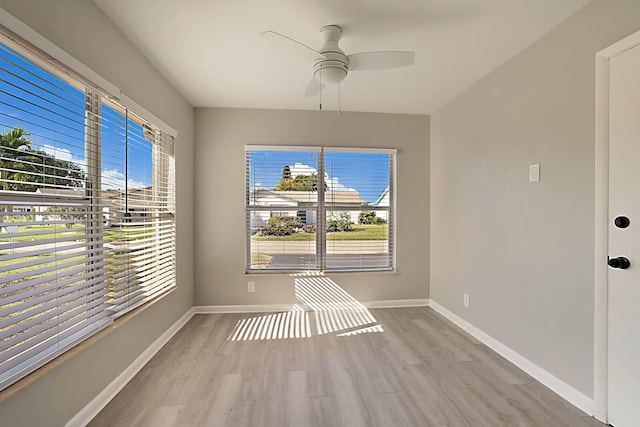 unfurnished dining area featuring ceiling fan and light wood-type flooring