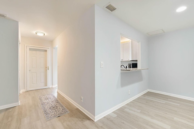 hallway featuring light hardwood / wood-style flooring