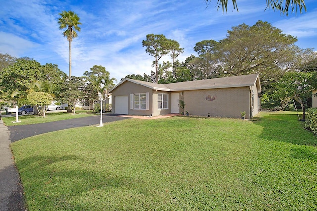 ranch-style house with a garage and a front lawn