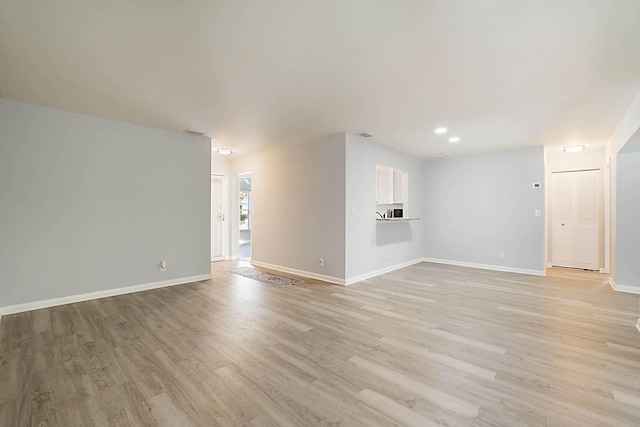 unfurnished living room with light wood-type flooring