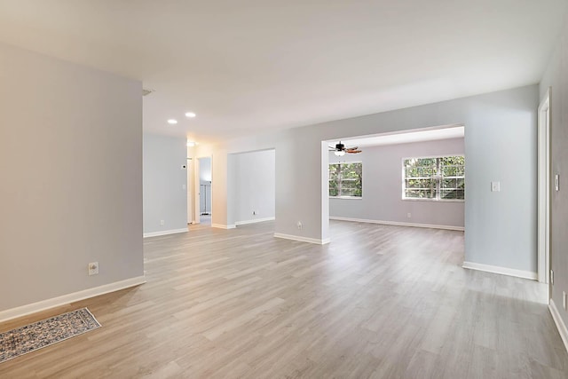 spare room featuring ceiling fan and light hardwood / wood-style flooring