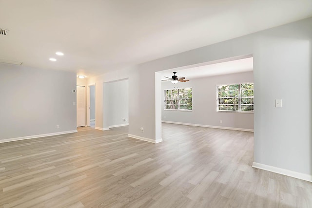 unfurnished room with ceiling fan and light wood-type flooring