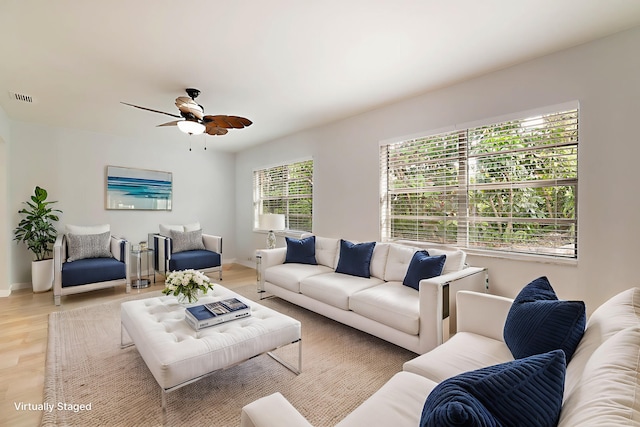 living room featuring ceiling fan and light wood-type flooring