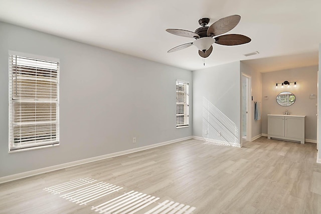 unfurnished room with ceiling fan and light hardwood / wood-style flooring