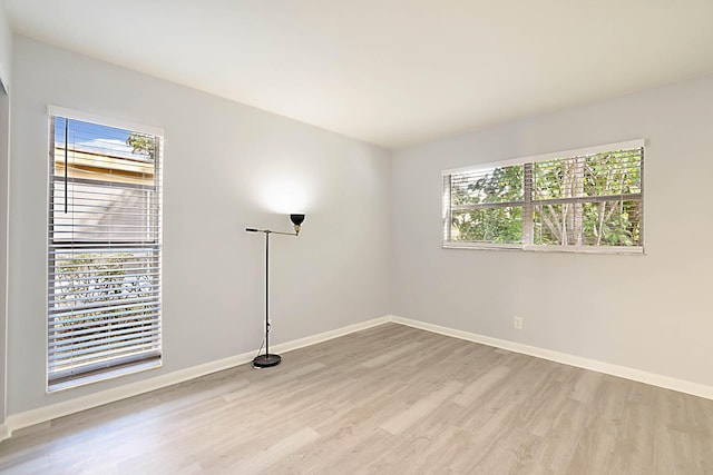 empty room with light hardwood / wood-style flooring