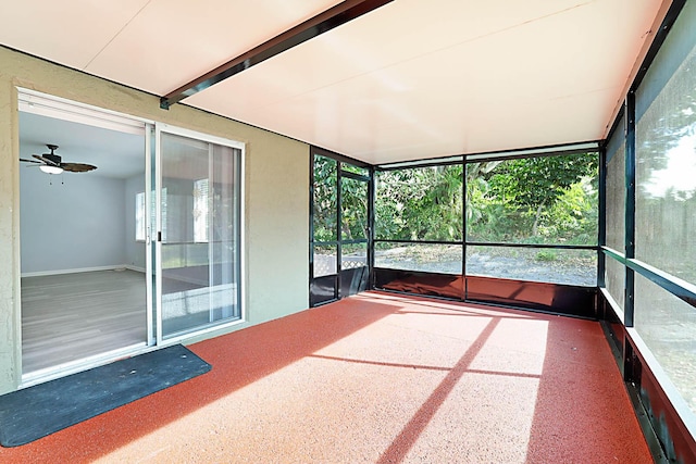 unfurnished sunroom featuring a wealth of natural light and ceiling fan