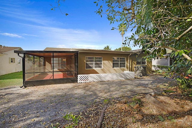 rear view of property with a sunroom