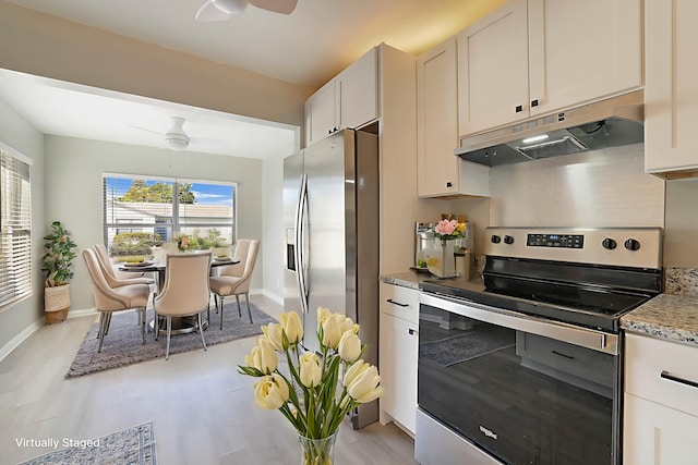 kitchen featuring light stone countertops, appliances with stainless steel finishes, white cabinets, and ceiling fan