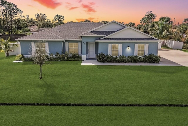 ranch-style house with a yard